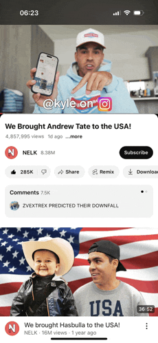 a phone screen shows a video of a man pointing at a cell phone