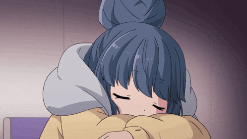 a girl with blue hair and a bun is sleeping with her eyes closed