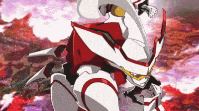 a robot with a red and white suit is standing in front of a red background .