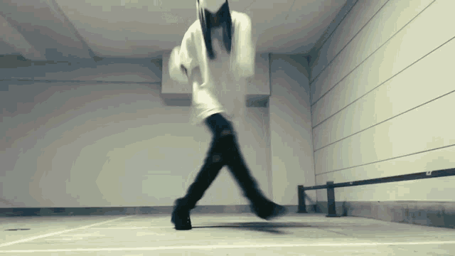 a person in a white hoodie is walking on a white line