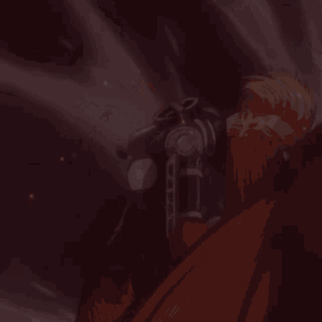 a man with blood on his face is standing next to a red cloth .