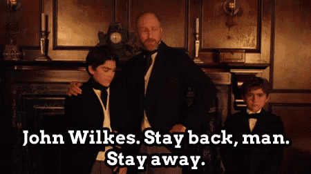 a man and two boys are standing in front of a fireplace with the words " john wilkes stay back man stay away " above them