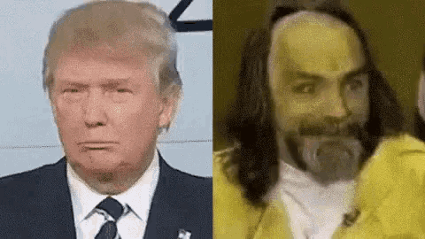 a man in a suit and tie is standing next to a man with a beard .