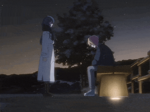 a man and a woman are standing next to each other in a dark scene