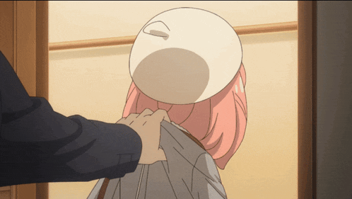 a woman with pink hair and a white hat is being helped by a man in a suit