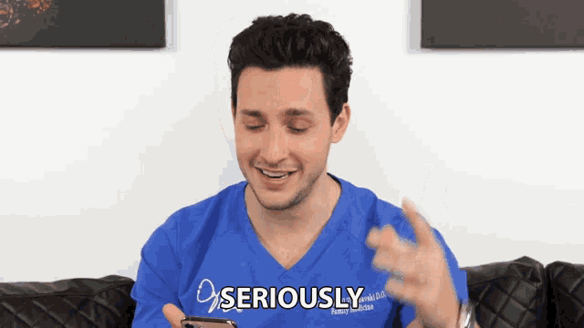 a man in a blue shirt that says seriously