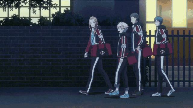 a group of people are walking in front of a brick wall and one of their jackets has a diamond on the front