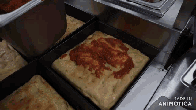 a bunch of pizzas are being made in an animatica