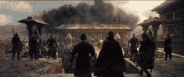a group of people standing in front of a building with smoke coming out of it .