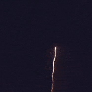 a white fireworks display against a dark purple background