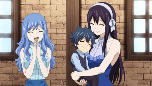 a woman in a blue dress is holding a little boy in her arms