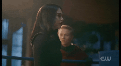 a man and a woman are standing in a boxing ring .