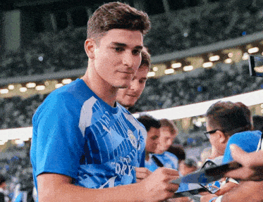a man in a blue shirt with super dry on it