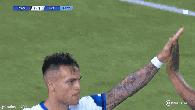 a soccer player wearing a white and blue jersey that says inter on it
