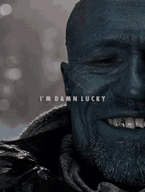 a close up of a man 's face with the words " i 'm damn lucky " on it