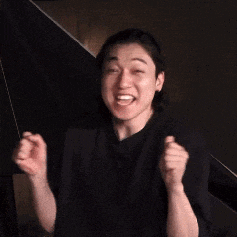 a man in a black shirt is making a funny face with his hands in the air