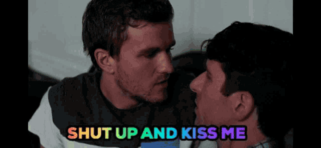 a man kissing another man with the words shut up and kiss me below them