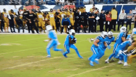 a football game is being played on a field with players in blue uniforms