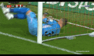 a soccer goalie is laying on the ground during a game between kay and bjk