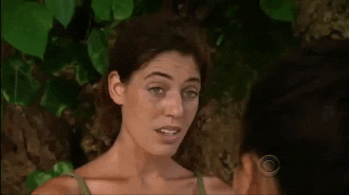 a woman is talking to a man in the jungle .