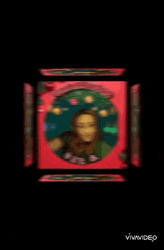 a picture of a woman in a red box with the words feliz navidad