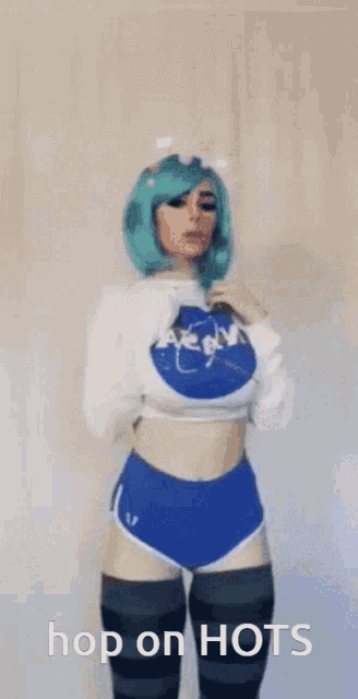 a woman with green hair is wearing a nasa sweater and shorts