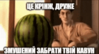 a man is holding a watermelon in front of a window with a foreign language caption .