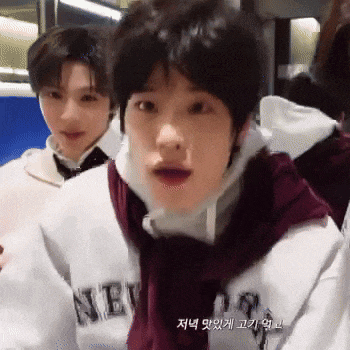 a man in a new york sweatshirt looks surprised
