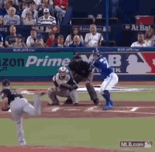 a baseball game is being played in front of a banner that says amazon prime