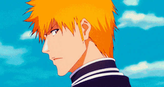 a close up of a man 's face with orange hair against a blue sky .