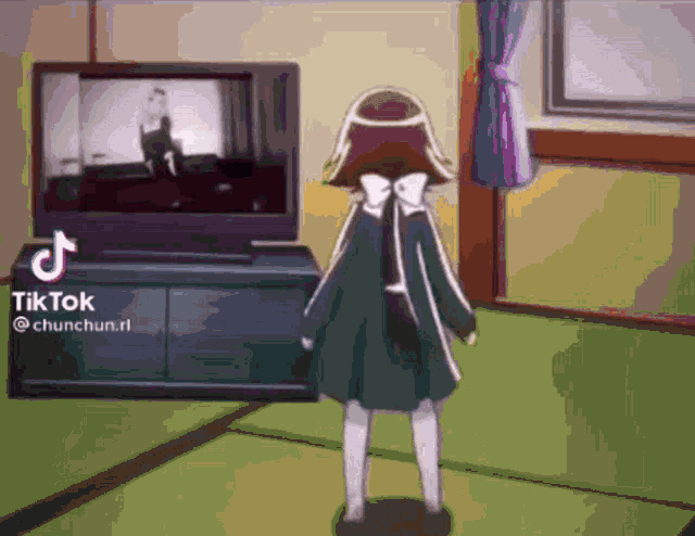 a little girl is standing in front of a television .