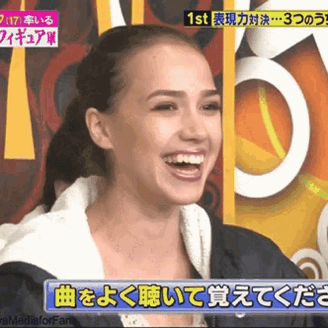 a woman is smiling in front of a sign that says ' 1st ' on it