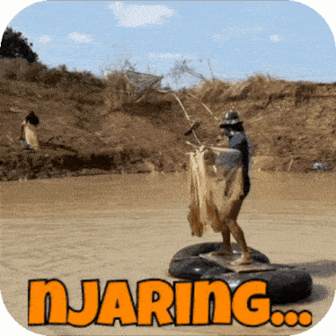 a man is standing on a raft in the middle of a river with the word njaring written above him