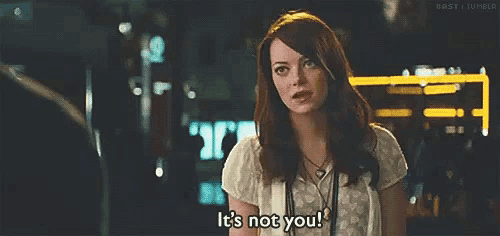 a woman is standing in front of a man and says `` it 's not you ! ''
