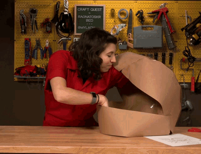 a woman in a red shirt is working on a craft quest ragnatoskr bed