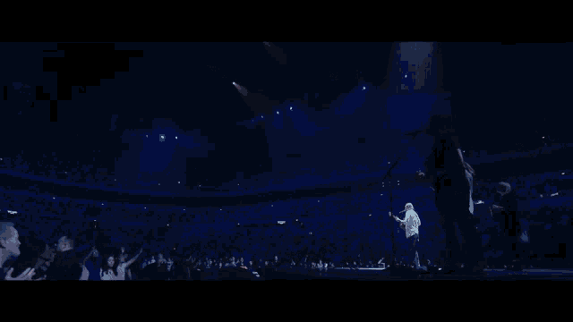 a blurry picture of a person 's face with a blue light behind them