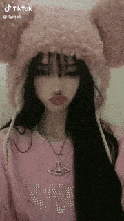 a girl wearing a pink hat and a pink shirt with the word thymoli on it