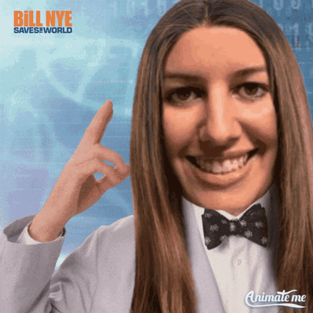 a woman in a white coat and bow tie is smiling and pointing up with bill nye saves the world in the background