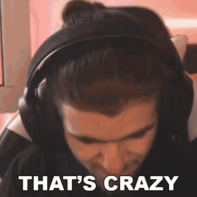 a man wearing headphones says that 's crazy while sitting in a chair .