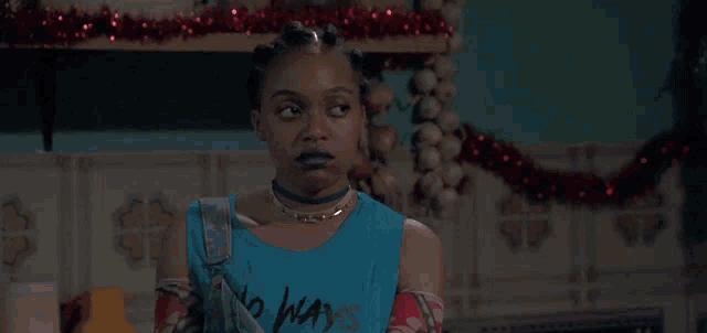 a woman wearing a blue tank top that says no ways on it