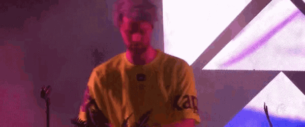 a man wearing a yellow shirt that says jbl on the front