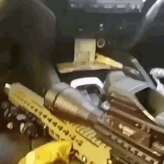 a person is holding a gun in a car with a bunch of money on the dashboard