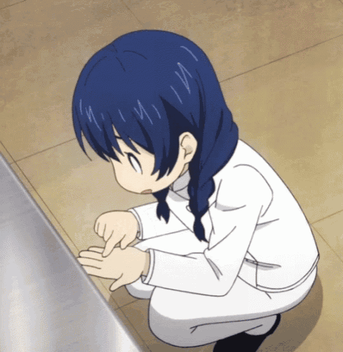 a girl with blue hair is kneeling down and pointing