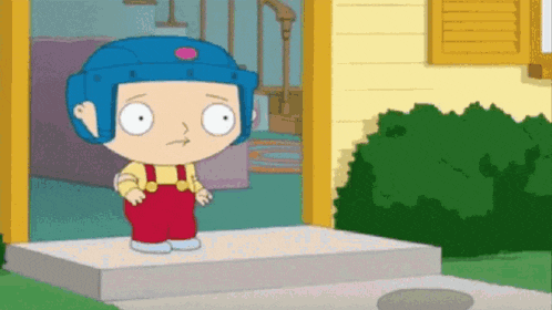a cartoon character wearing a blue helmet is standing in front of a house .