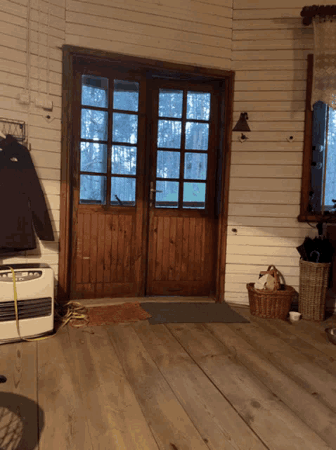 a room with a wooden door and a heater on the floor