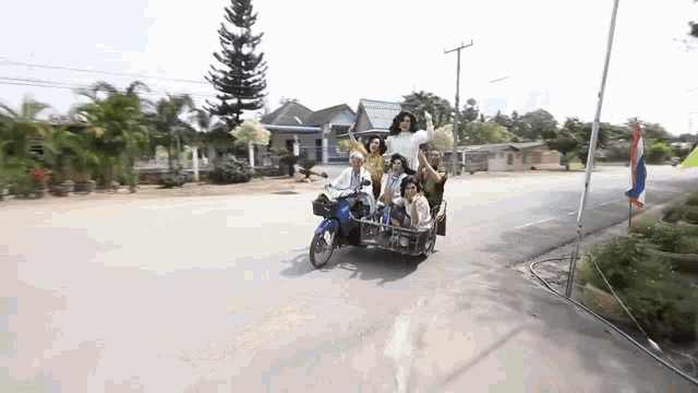 a group of people are riding on a motorcycle with a sign that says " welcome "