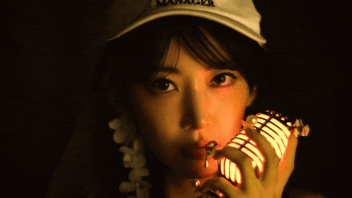 a woman wearing a hat that says manager
