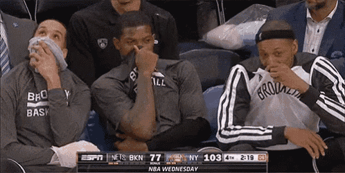 a group of brooklyn nets players sitting in the stands