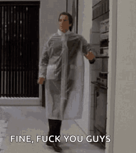 a man in a clear plastic coat is standing in a hallway .