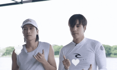two men are standing next to each other and one has a rip curl shirt on